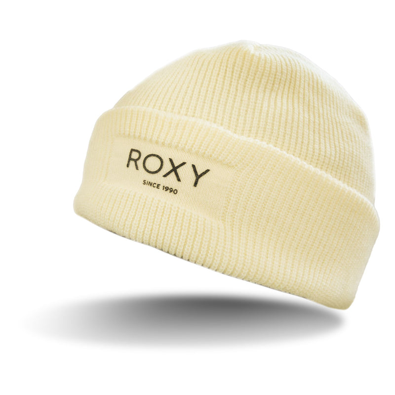 A cream-colored Roxy Blizzard Beanie for women with a folded brim and “ROXY SINCE 1990” embroidered on the front. This chunky knit beanie floats above a shadow, blending cozy style with effortless flair.