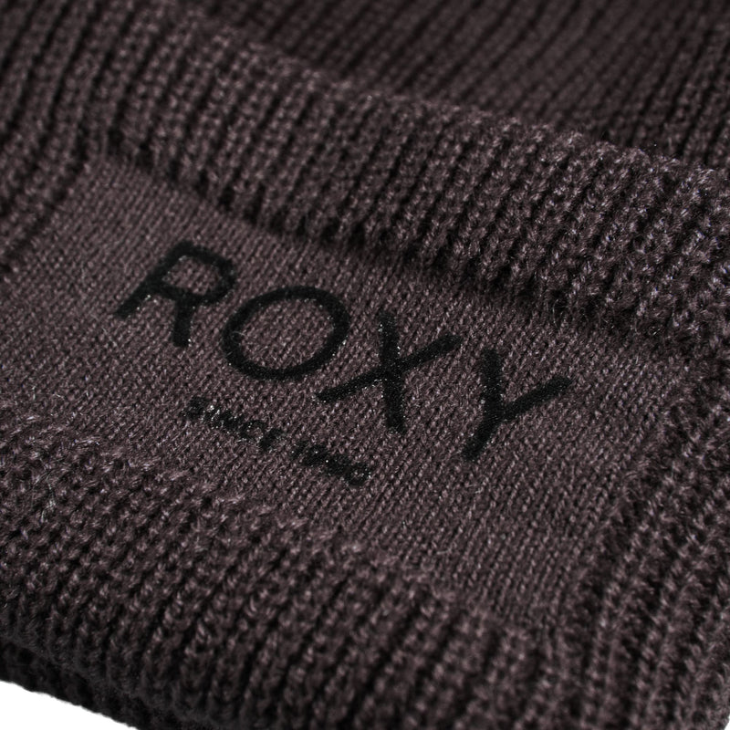 Close-up of a ribbed dark brown Roxy Folker Beanie with the brand name embroidered on the front fold.