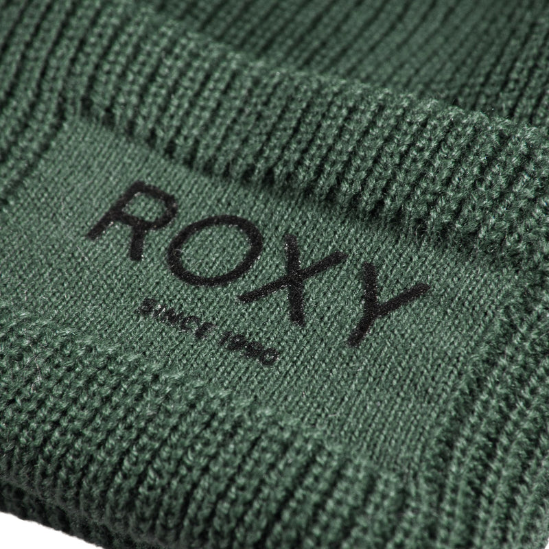 Close-up of a ribbed dark green Roxy Folker Beanie featuring a patch with the text ROXY and SINCE 1990.