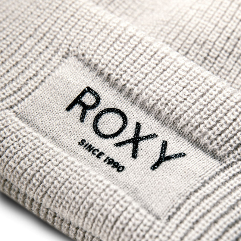 Close-up of a ROXY Folker Beanie in a rib knit, featuring a patch that reads ROXY SINCE 1990.