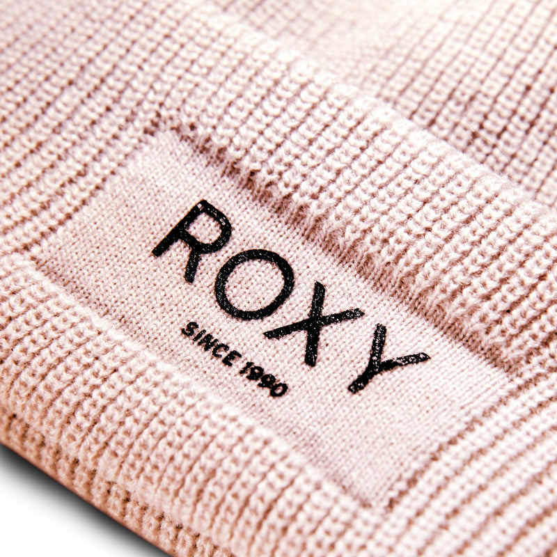 Close-up of a Roxy Folker Beanie in rib knit featuring a patch with the text ROXY SINCE 1990 embroidered in black.