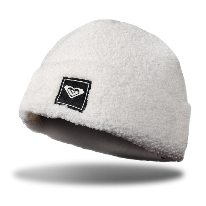 White Roxy Valwood Beanie with a rolled cuff and a square black logo patch on the front.