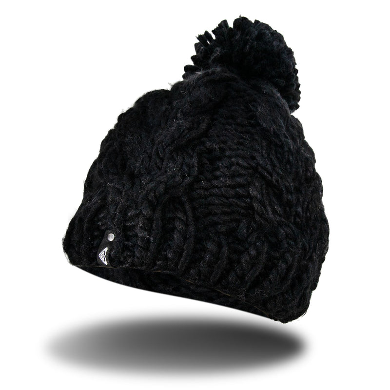 A Roxy Winter Beanie in chunky black knit with a pom-pom, featuring a soft fleece lining and a small logo tag, floats above a shadow on a white background.