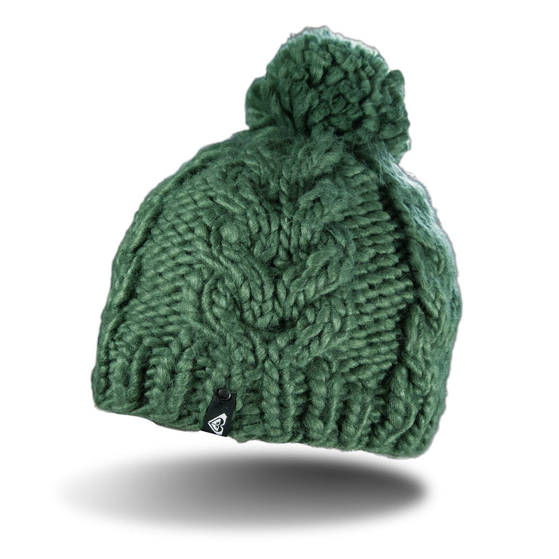 The Roxy Winter Beanie is a chunky, hand-knitted green women’s hat with a large pom-pom on top and a small black logo tag on the brim. Designed for extra warmth, it features cozy fleece lining and is displayed against a white background with a soft shadow underneath.