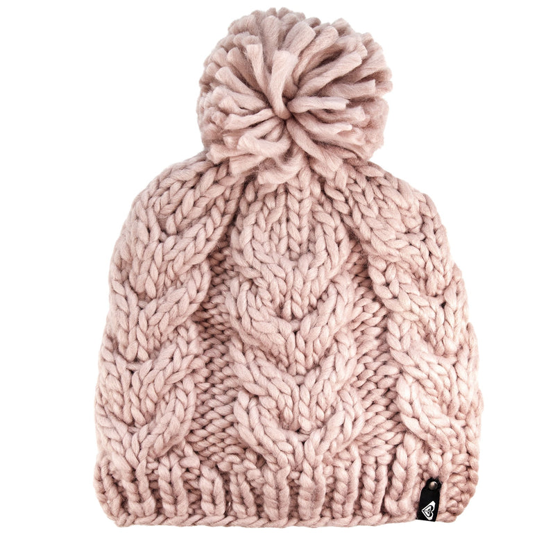 The Roxy Winter Beanie in Zephyr pink features a chunky knit design with a large pom-pom on top, a cozy fleece lining for added warmth, and is finished with a small black tag at the bottom edge.