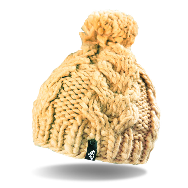 A Roxy Winter Beanie for women in chunky yellow knit, featuring a cozy fleece lining, a playful pom-pom on top, and a small black tag near the brim. The beanie is displayed against a white background with a soft shadow beneath it.