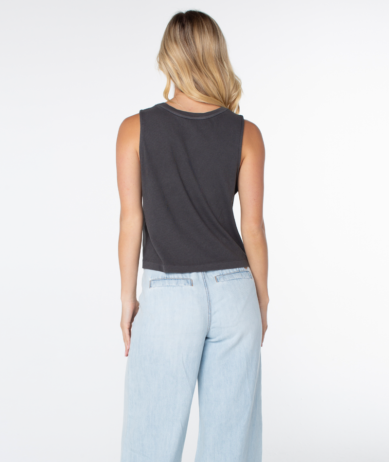 A woman seen from behind wearing a charcoal grey cropped Palm Tree Resort Wildflower Tank and light wash jeans.