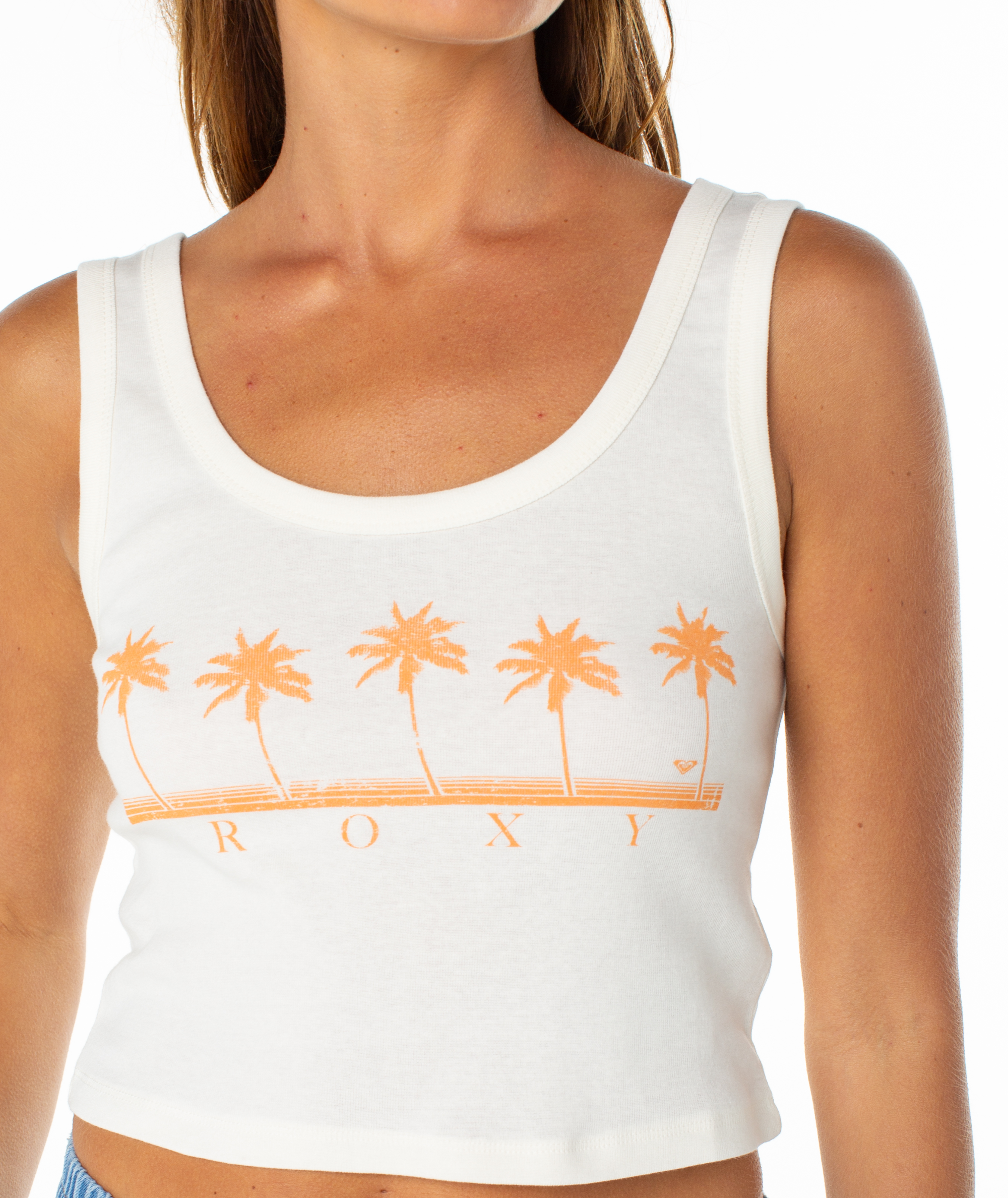 Woman wearing a Roxy Five Palm Stripe Tee, featuring an orange palm tree graphic and ROXY text on the front, paired with blue bottoms for lightweight comfort and effortless coastal style.
