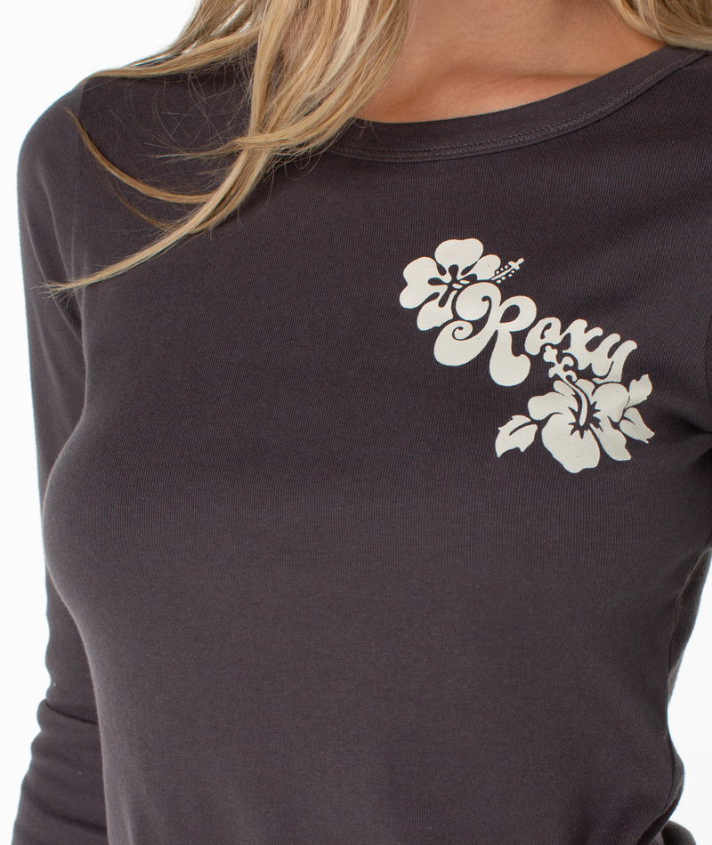 Close-up of a charcoal Roxy Hibiscus View Long Sleeve Top with a white graphic of flowers and stylized coastal cool text on the chest.