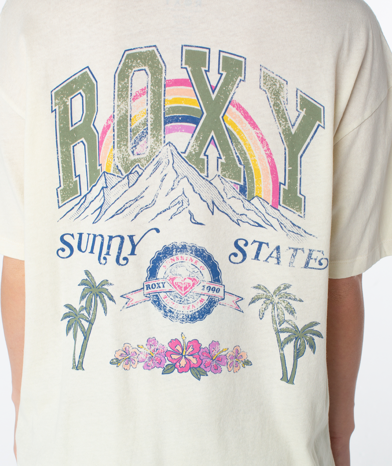 Off-white oversized Sunny State Tee with a vintage-style back graphic featuring a mountain range, rainbow, palm trees, and hibiscus flowers with Sunny State text.