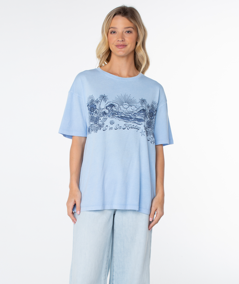 Roxy On Holiday Top: a light blue oversized tee with a graphic illustration of a beach scene and the text I’m On Holiday.