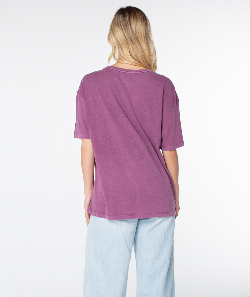 Back view of a person wearing a plain, oversized plum-colored lightweight Roxy In The Waves Top and light blue jeans.
