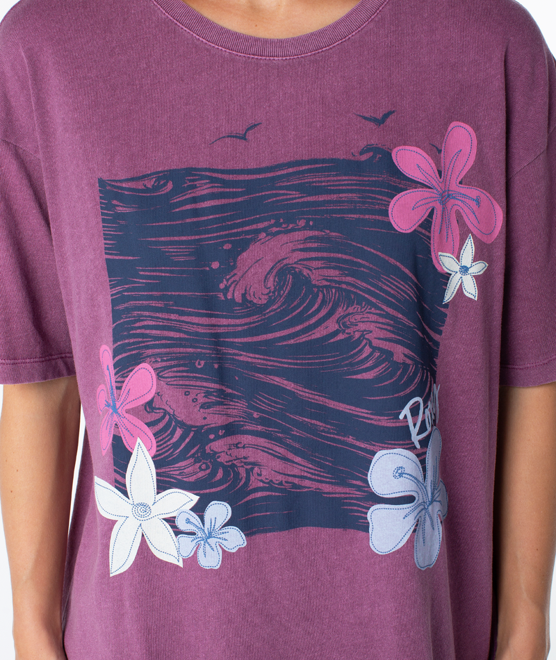 Roxy In The Waves Top: a beachy-chic, purple short-sleeved t-shirt featuring a dark blue square graphic of ocean waves, accented with pink and light blue hibiscus-style flowers.