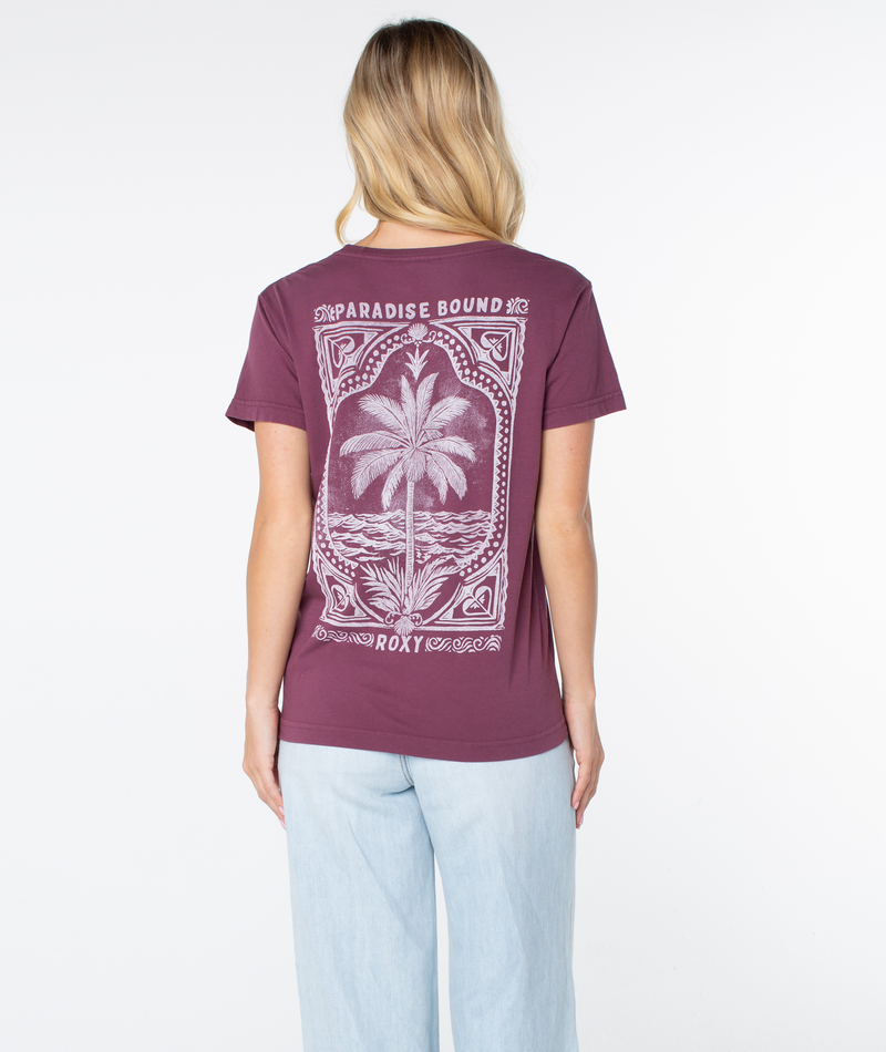 A person seen from the back wearing a maroon Roxy Simple Palm Top featuring a graphic of a palm tree, ocean waves, and the text Paradise Bound.