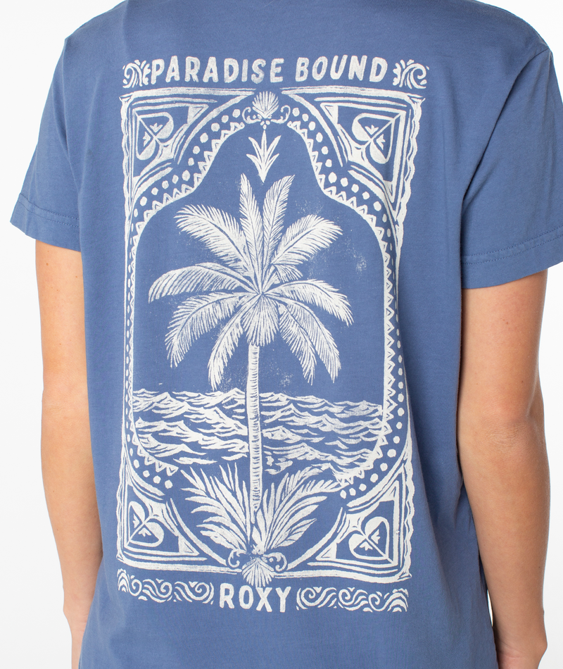 Back view of a blue Simple Palm Top featuring a white graphic of a palm tree on a beach inside a decorative frame with the words PARADISE BOUND and ROXY.