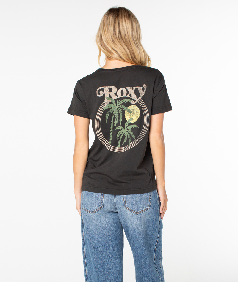 Back view of a person wearing a black Palm Tree Resort Top featuring a circular graphic on the back with palm trees, a yellow sun, and stylized Roxy text.