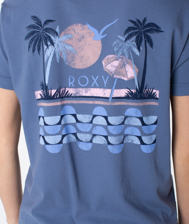 Blue slouchy Palm Geo Top with a beachy graphic on the back depicting palm trees, a sun, a beach umbrella, a bird, and stylized ocean waves, with the text ROXY in the center.