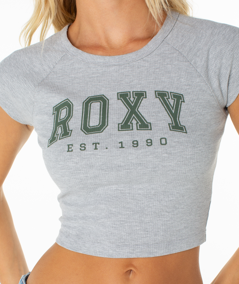 Gray ribbed, short-sleeved Roxy Academy Tee with ROXY and EST. 1990 printed in green across the chest.