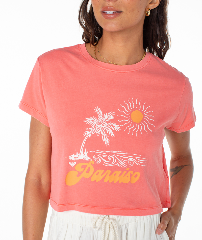 Roxy Paraiso Screen Tee in coral, featuring a cropped fit and a graphic of a palm tree, sun, and the word Paraiso in yellow cursive text.