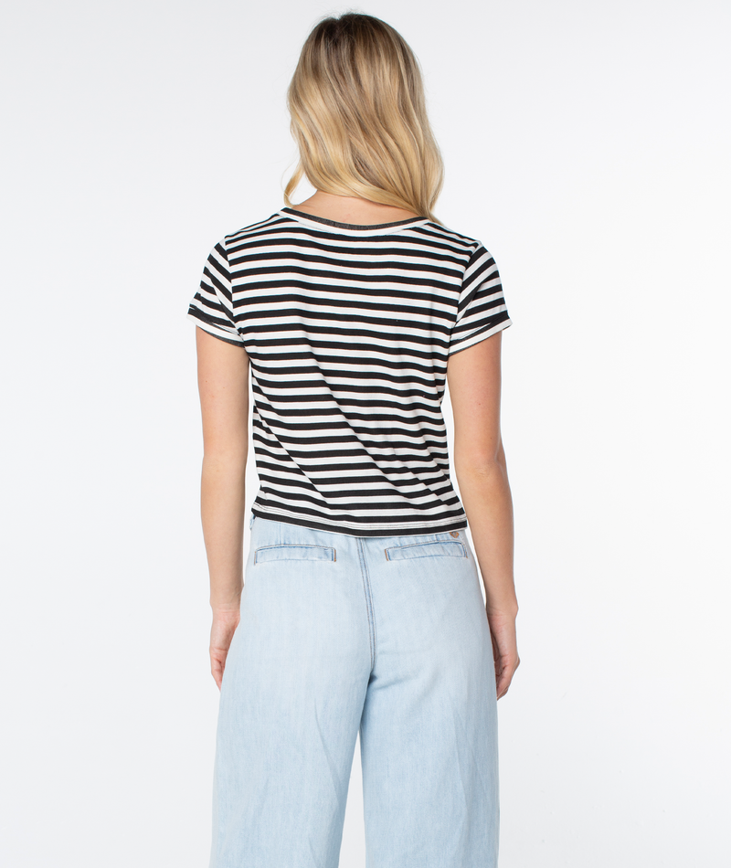 A person with long blonde hair is seen from behind wearing the Vintage Roxy Stripe Top by Roxy with light blue jeans, set against a plain white background.