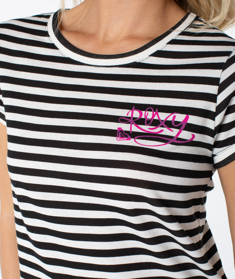 A person wears the Vintage Roxy Stripe Top, featuring black and white stripes with pink Roxy lettering and a heart logo—this spring essential channels coastal cool, shown from just the upper torso and neck.