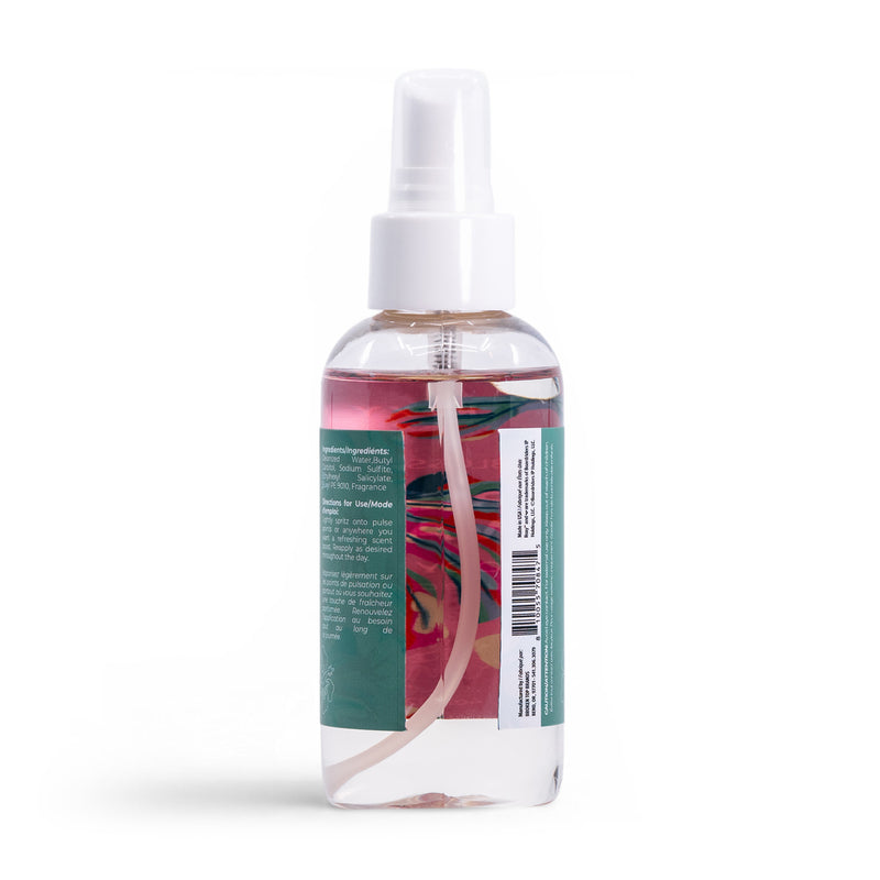 A clear plastic spray bottle of Roxy Hibiscus Wave Body Mist with a white cap and green label featuring the colorful Hibiscus Wave design, partially visible through the liquid, set against a white background.