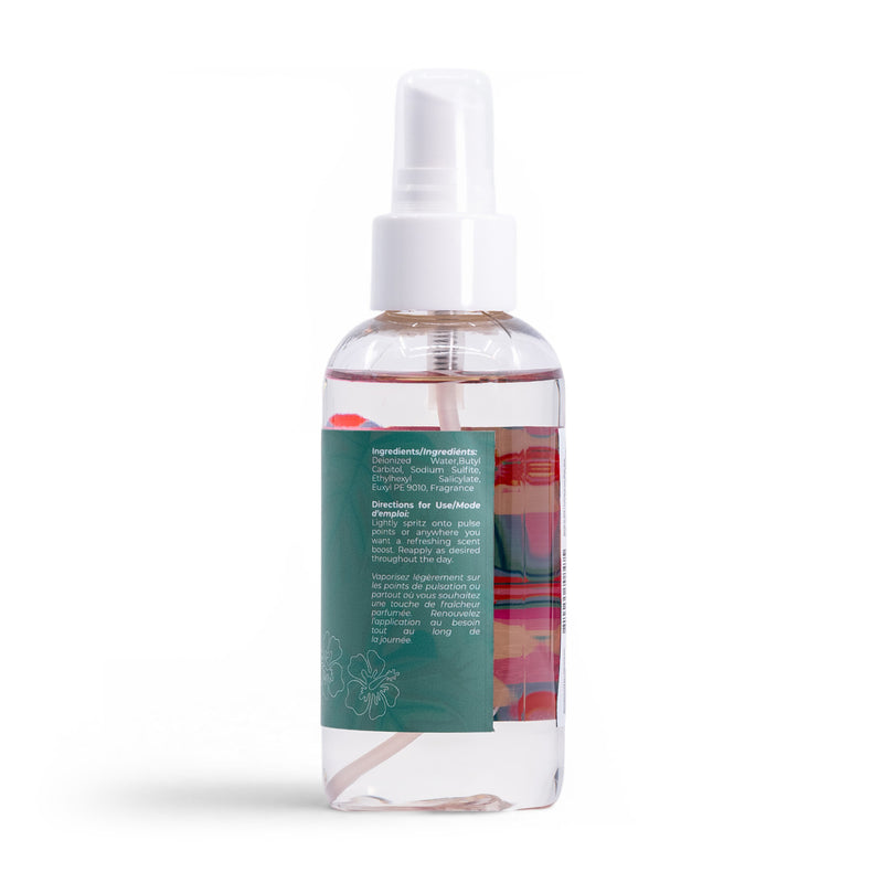 A clear plastic spray bottle with a white nozzle and cap holds Roxy Hibiscus Wave Body Mist. Its green label with white text and floral accents details ingredients and usage instructions. The background is white.
