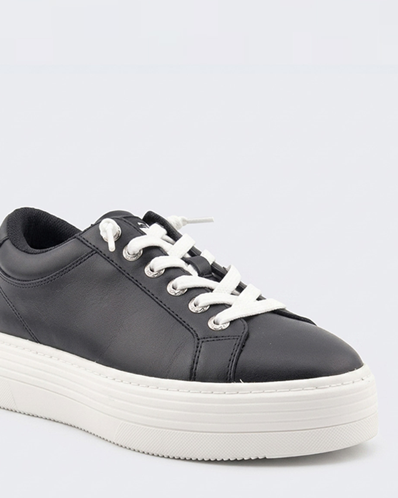 The Roxy Sheilahh 2.0 Sneaker features black leather, white laces, and a thick white platform sole, displayed against a plain light background.