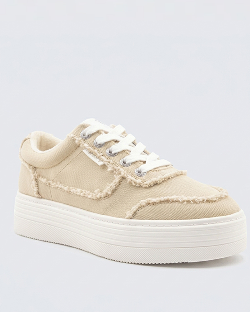 The Roxy Sheilahh 2.0 Sneaker is a beige canvas shoe with frayed edges, white stitching and laces, silver eyelets, and a thick white platform sole, shown on a light gray background.