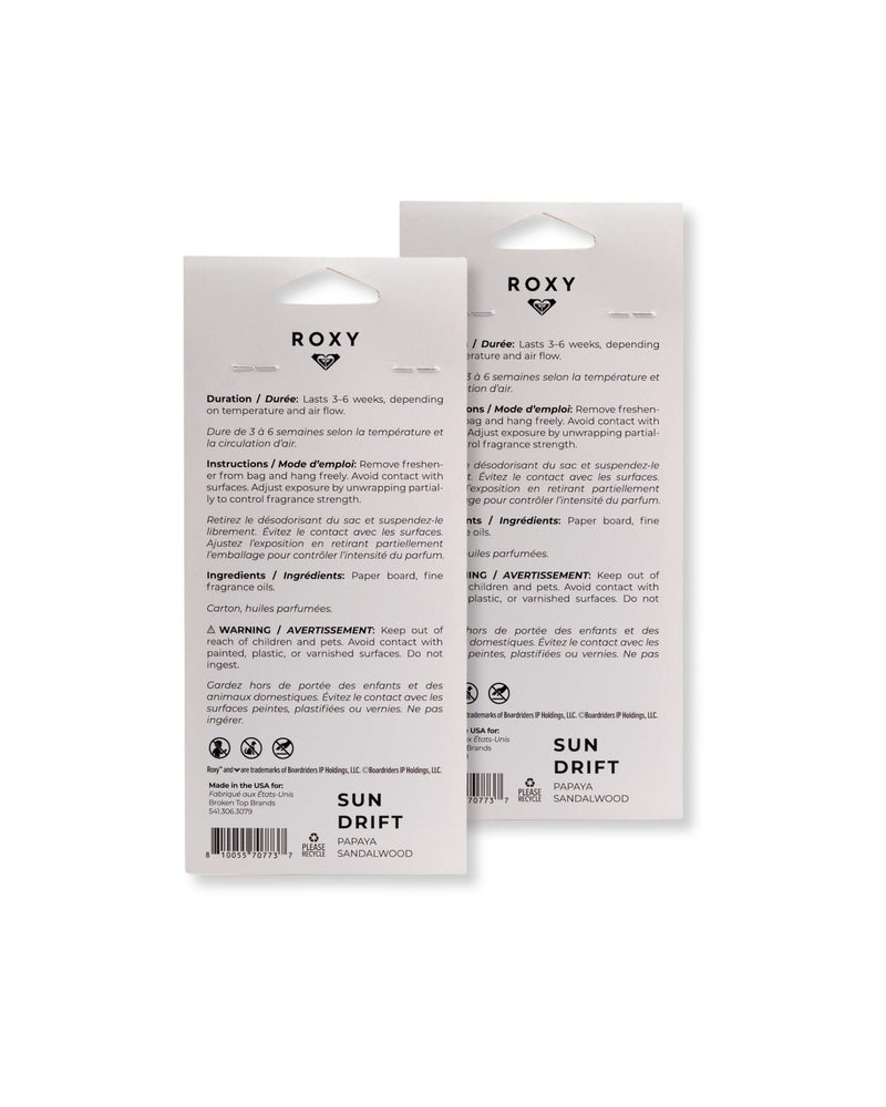 Back view of two ROXY Air Freshener 2-Pack Variety Pack packages displaying text with usage instructions, ingredients, warnings, and branding in English and French on a white background. The packaging highlights the creamy sandalwood and juicy papaya blend that creates a sunlit scent for any space.