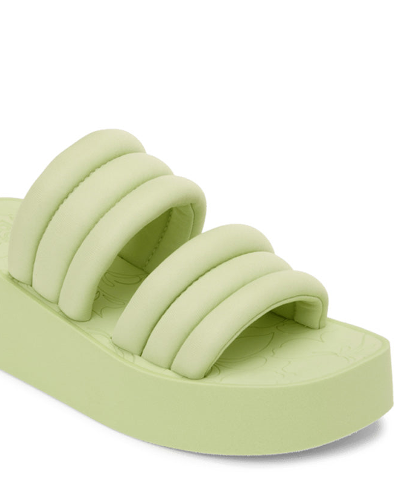 Embrace 90s nostalgia with the Roxy Totally Tubular Sandal, featuring a light green platform, three padded straps, and a textured sole—ideal for laid-back beach style.