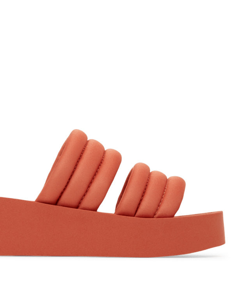 Side view of the Roxy Totally Tubular Sandal in orange, with a chunky sole and triple-ridged puffy strap—ideal for adding 90s flair to your beach look.