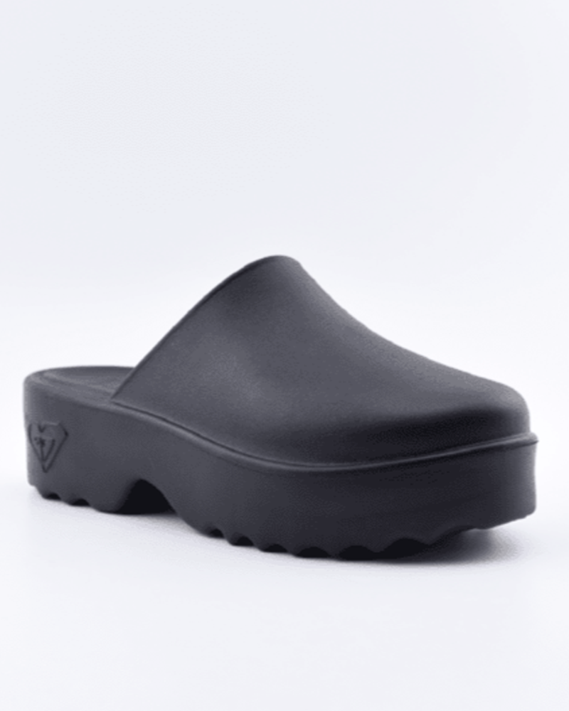 The Roxy Maddy Clog is a black slip-on platform mule featuring a closed, rounded toe and chunky ridged sole, shown on a white background.
