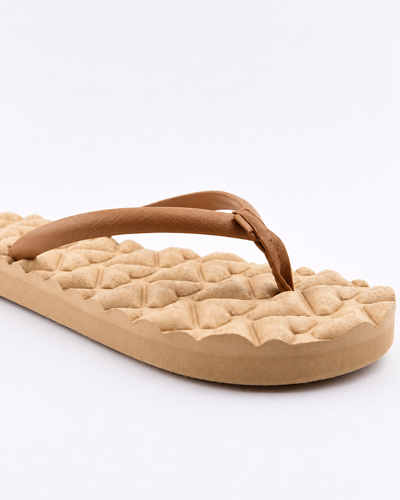 A close-up of the Roxy Shoresoft Sandal highlights its cushioned footbed, beige textured sole, and tan straps, photographed on a white background.