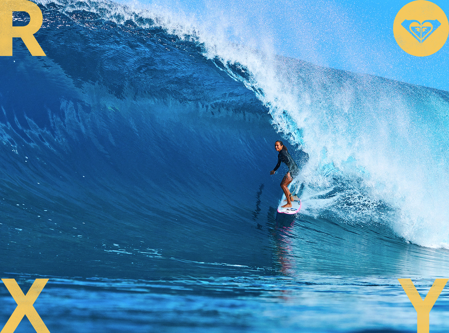 Person surfing a large wave with a visible brand logo in the corner.